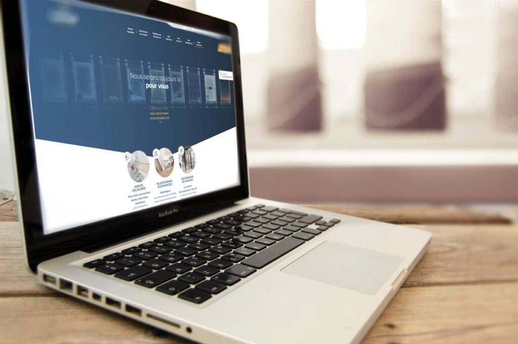 Page accueil du site internet de Sachot sur un écran de pc portable posé sur un bureau